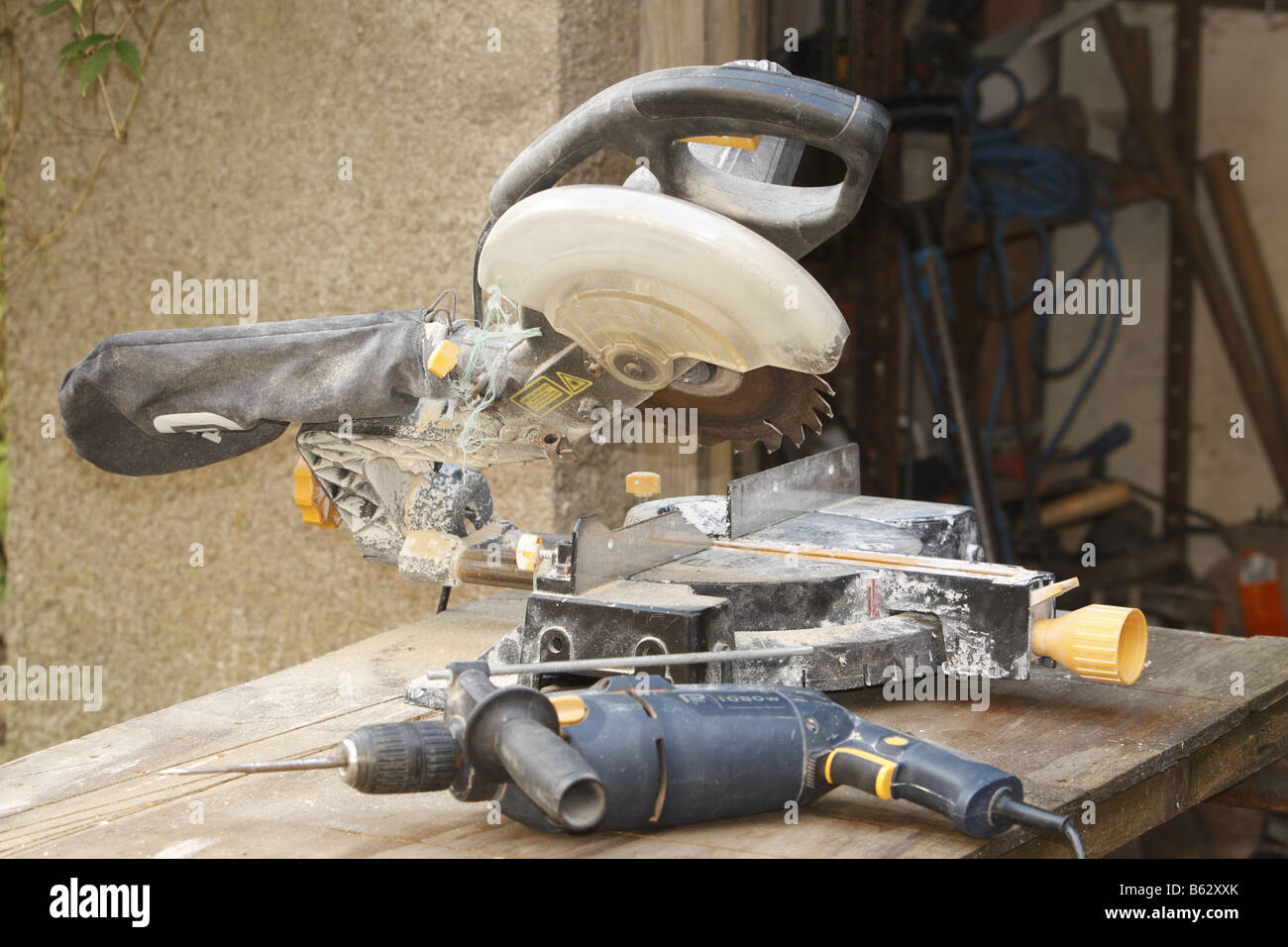 Electric drill and circular saw laying on a workbench Stock Photo