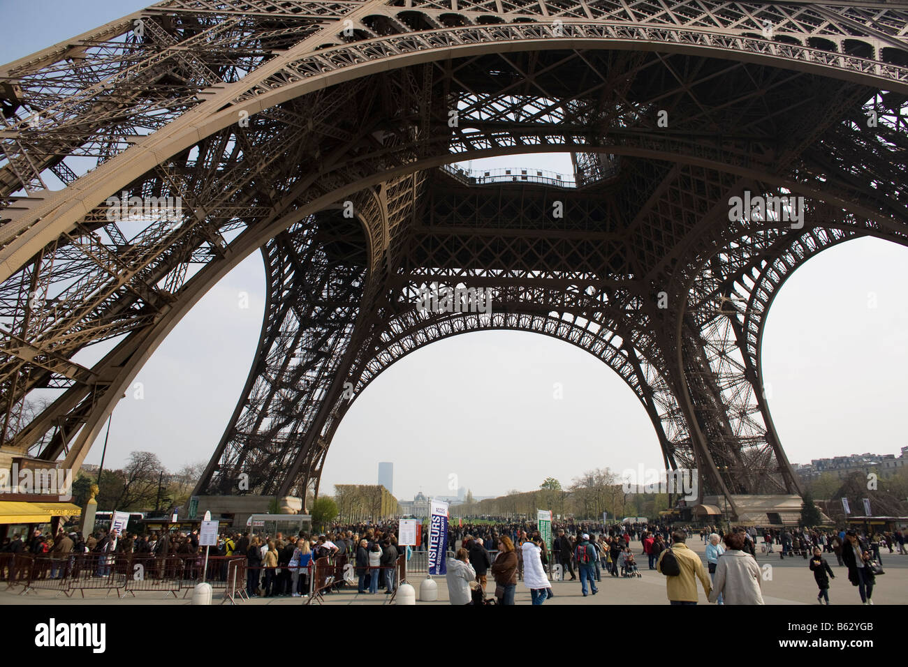 Visitors to the Eiffel Tower wait in line to observe Paris’ iconic
