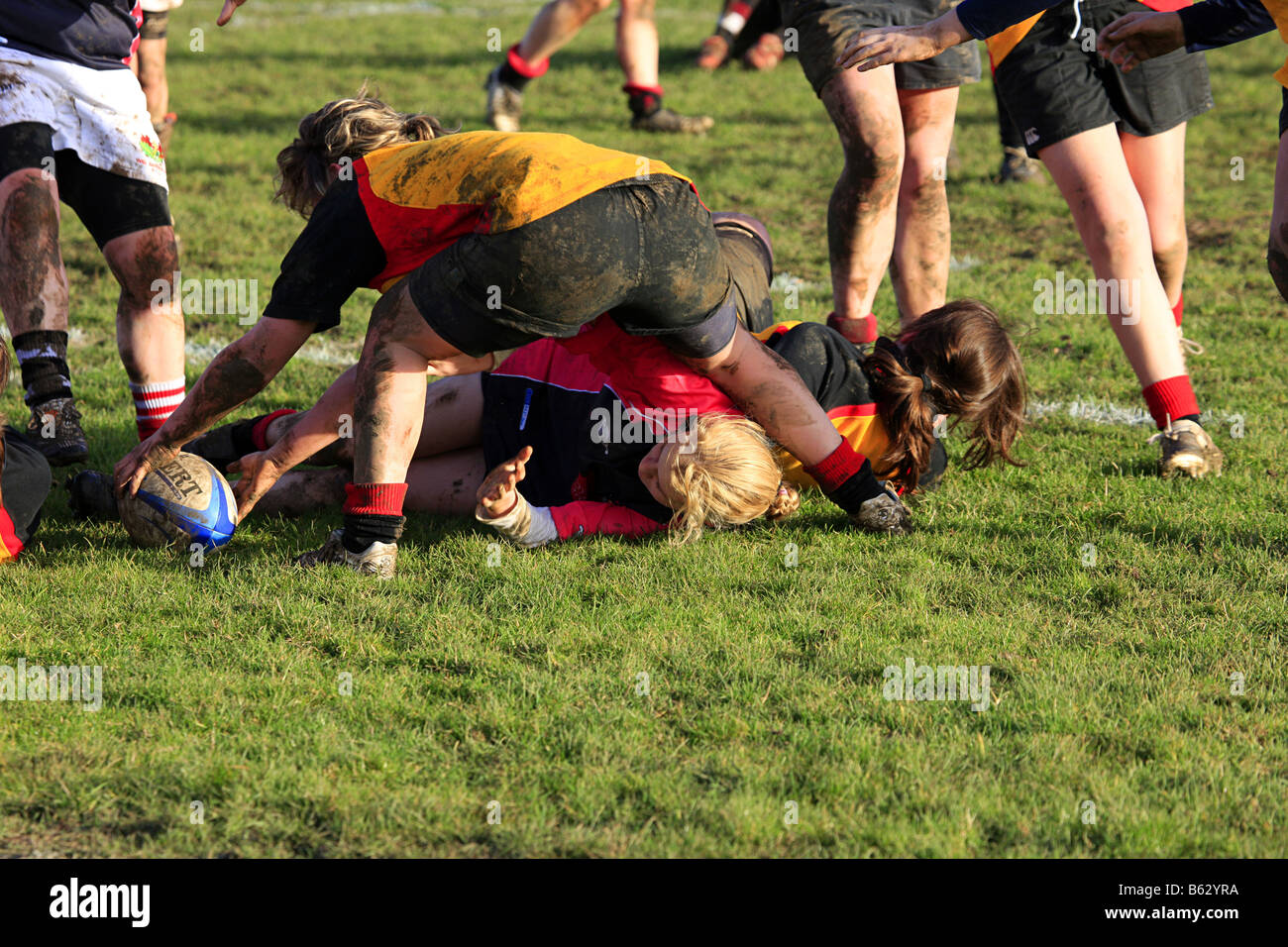 Teenage girls playing Rugby on a cold wet autumn afternoon Stock Photo ...