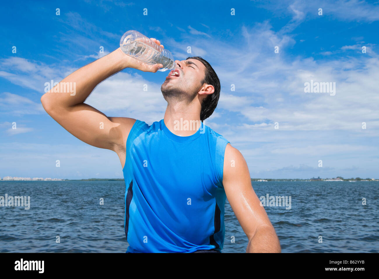 Young man drinking water from a water bottle Stock Photo - Alamy