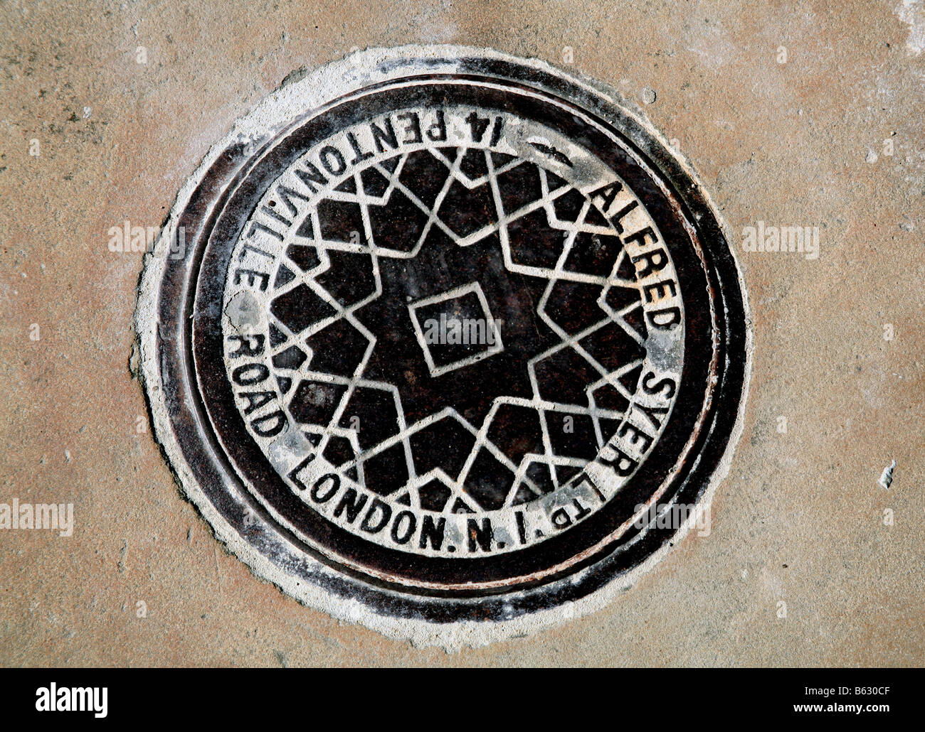 Coal hole cover in London pavement Stock Photo