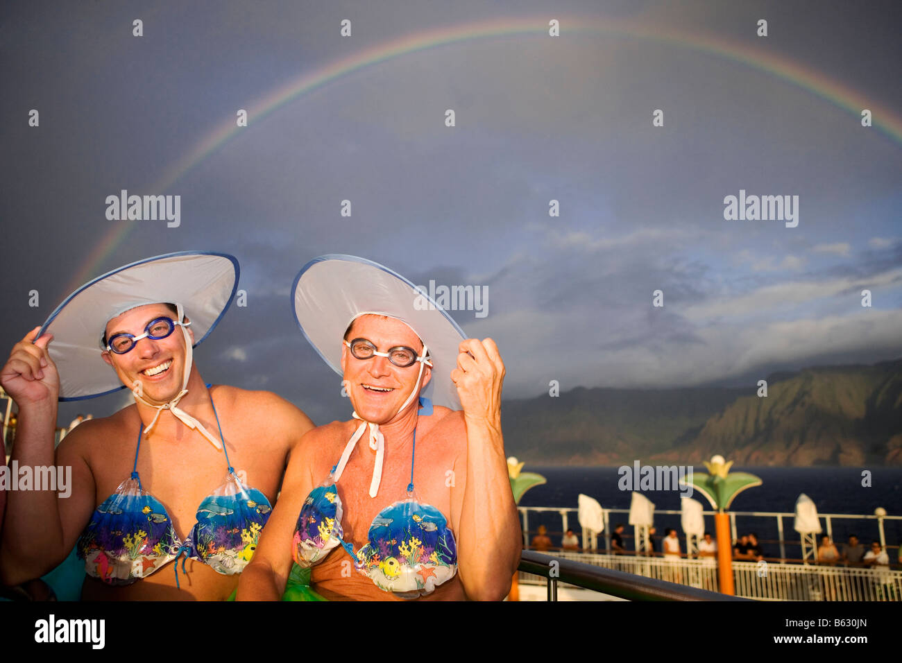 Two gay men wearing bikini tops and dancing Stock Photo - Alamy