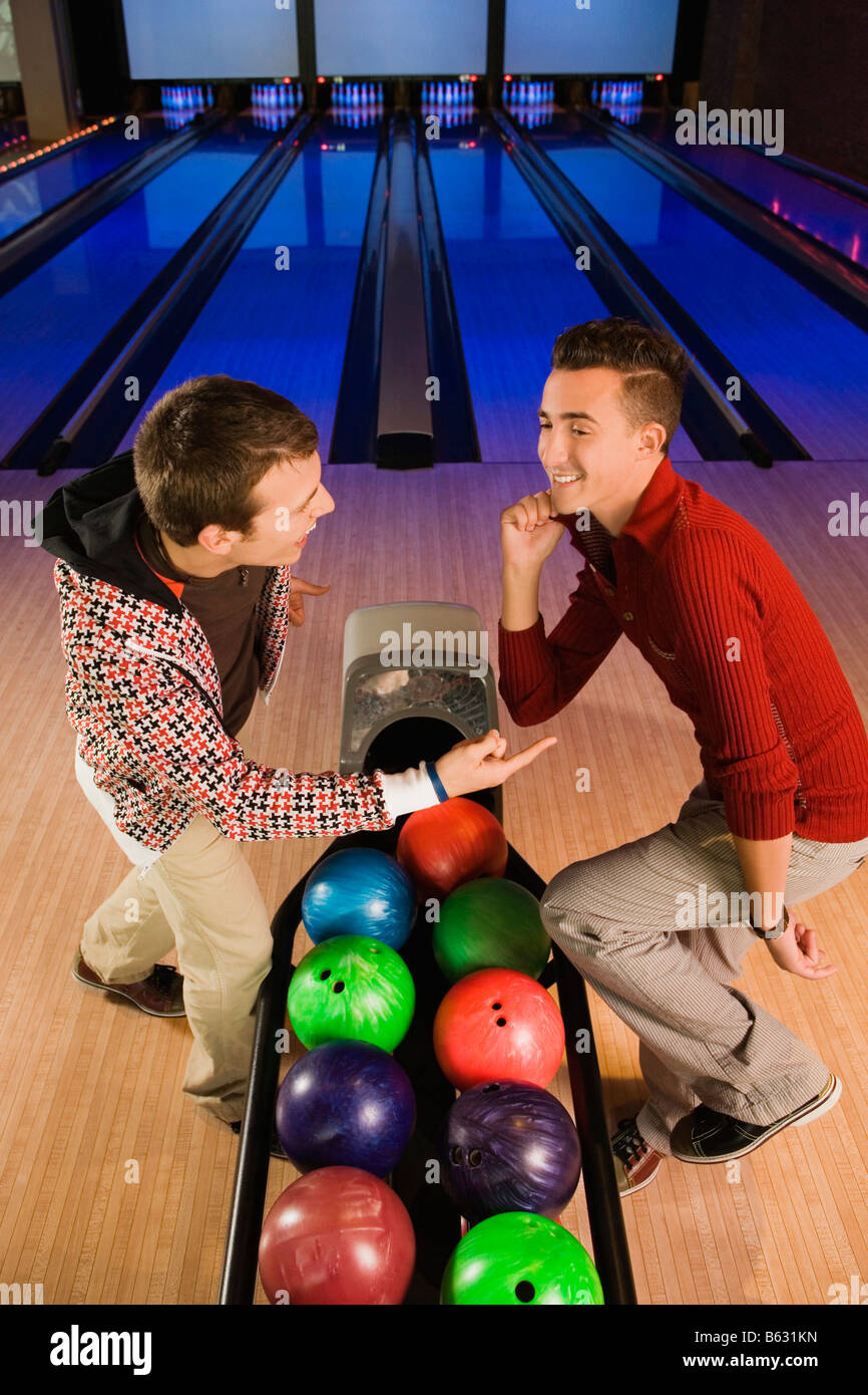 Two young men dancing in a bowling alley Stock Photo