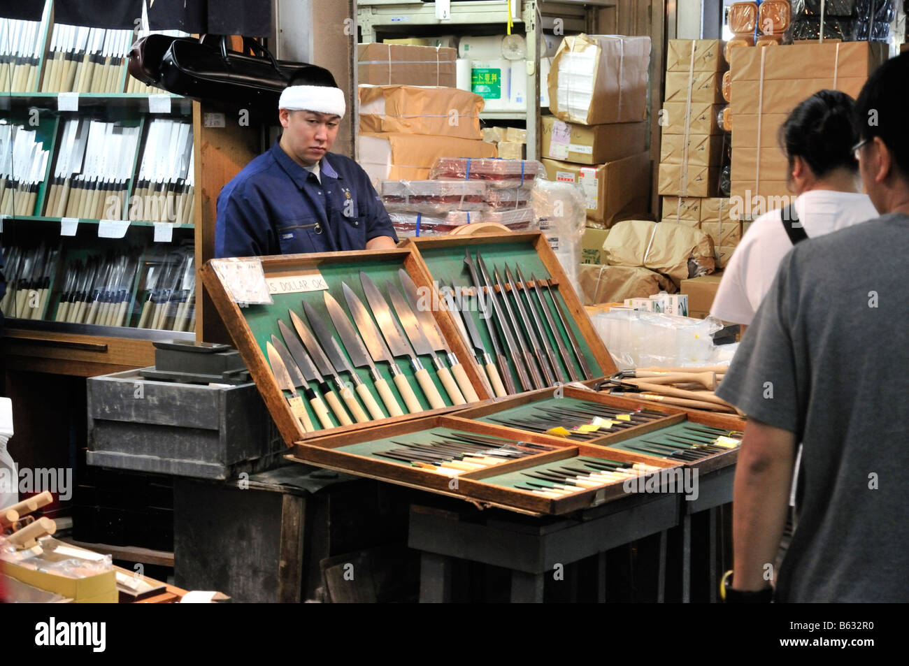 Knife salesman behind display of knives at the Tsukiji fish market