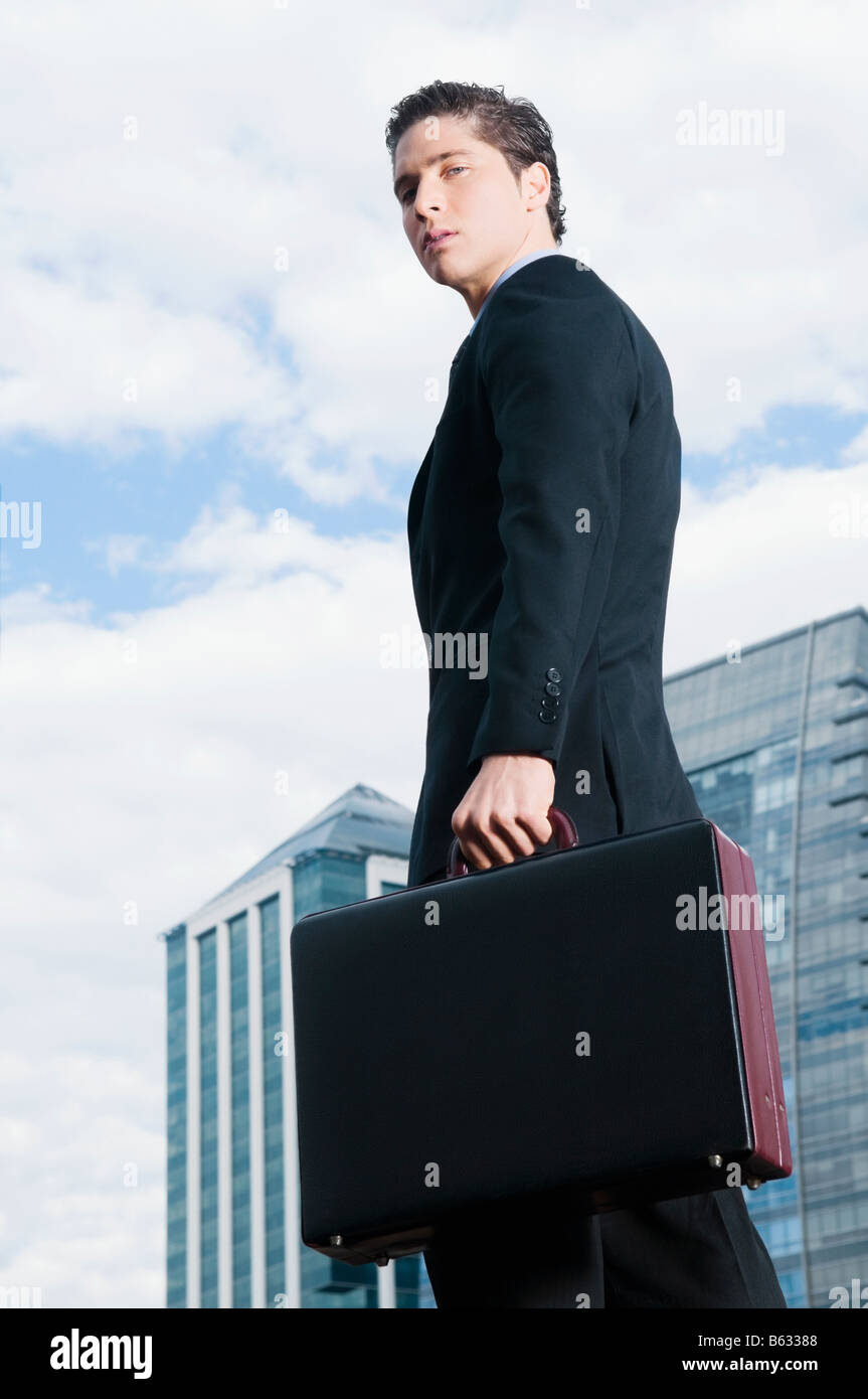Portrait of a businessman holding a briefcase Stock Photo - Alamy