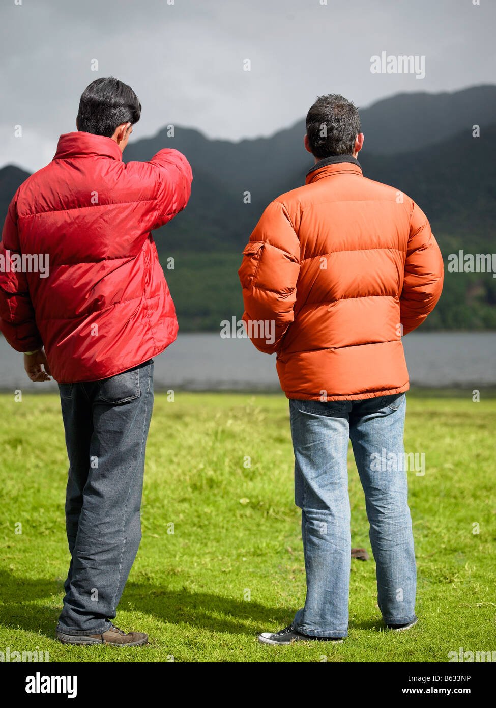 Rear view of two young men standing Stock Photo - Alamy