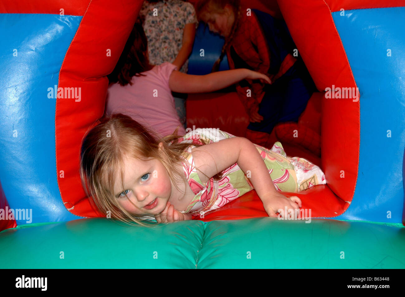 Children play on a bouncy castle. Stock Photo