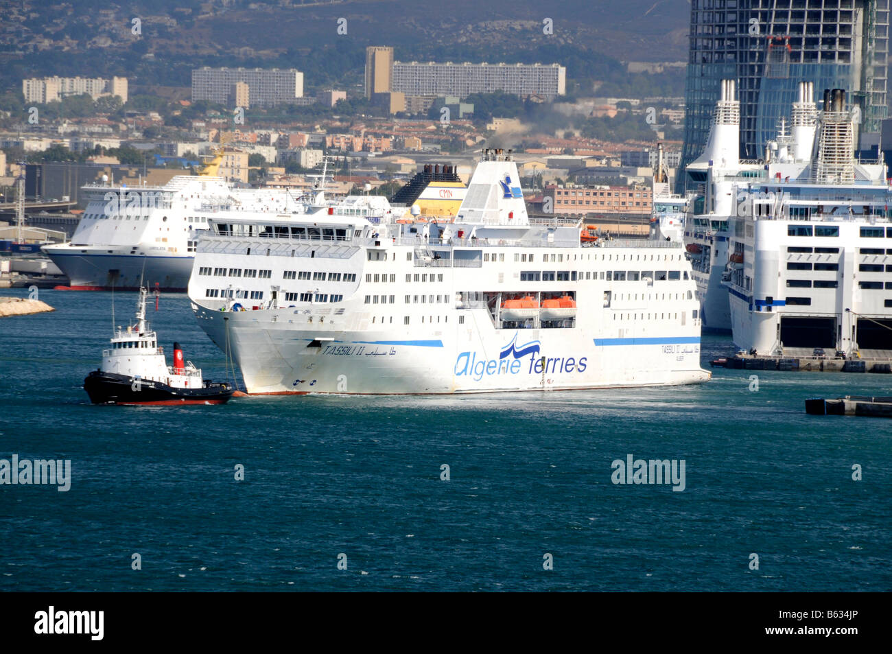 A passenger / car ferry being escorted by two tugs leaving the port at Marseille in the south of