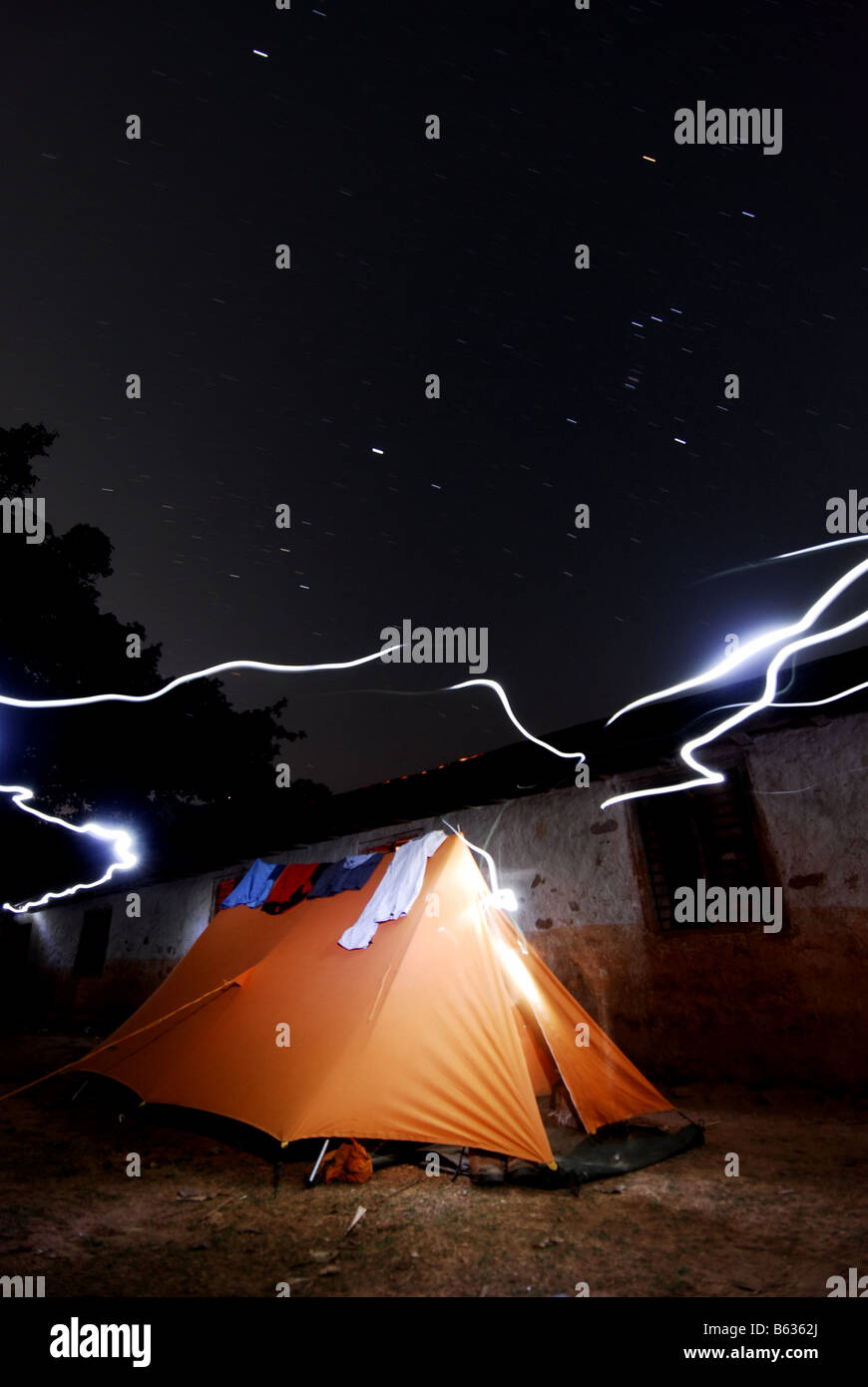 Camping in Nepal while on trek with the lights of campers torches and the stars Stock Photo