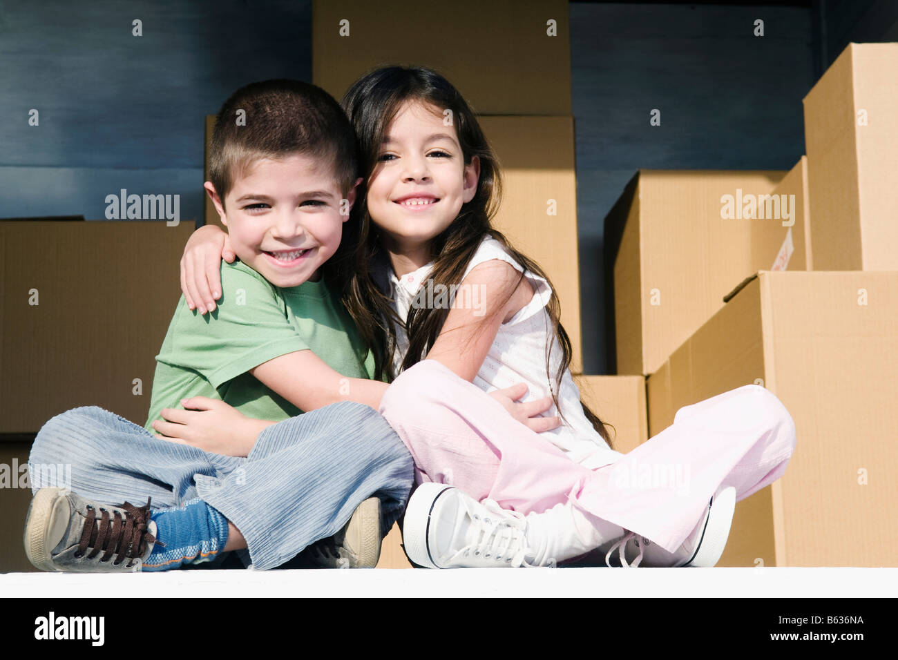 Portrait of a girl and a boy hugging each other Stock Photo - Alamy