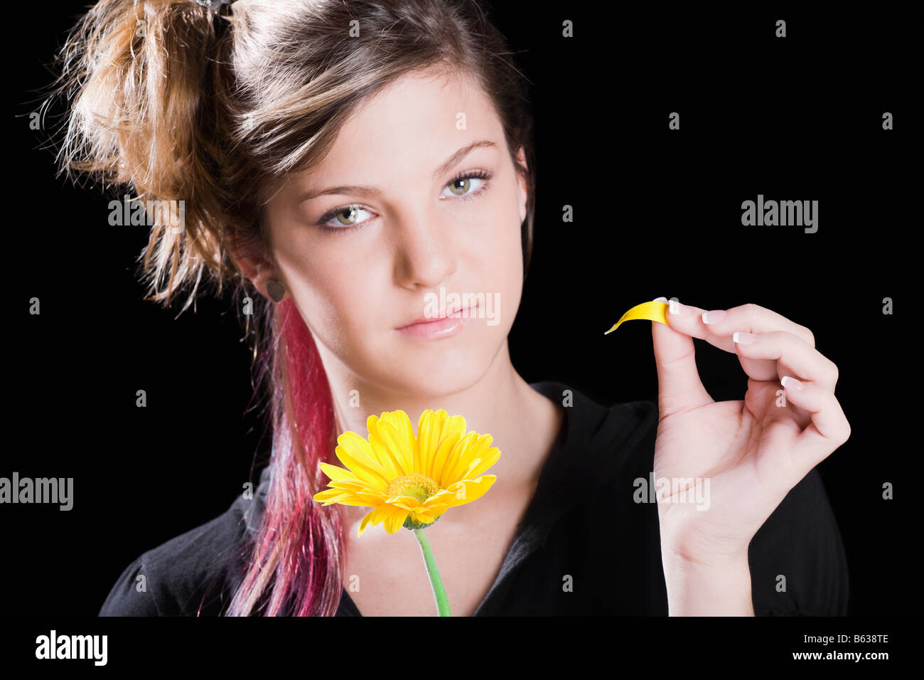 Portrait of a teenage girl holding a flower Stock Photo - Alamy