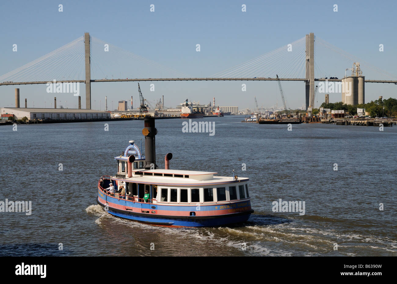 Ferry crossing the Savannah River America USA and road bridge