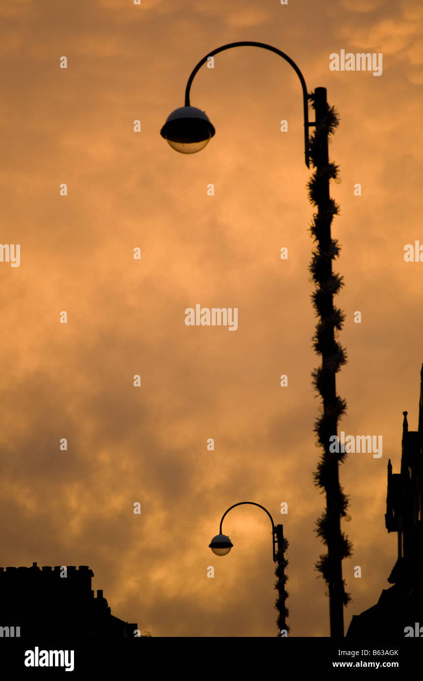 glowing light on underlit Mammatus clouds at sundown, moody oppressive eerie feeling, lamppost in silhouette, UK Stock Photo