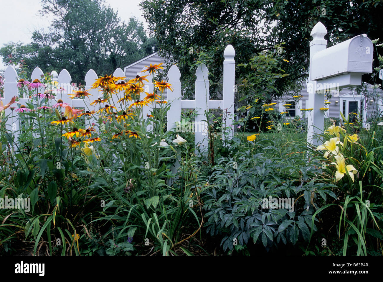 Connecticut Garden White Picket Fence Spring Flowers and Mailbox Stock