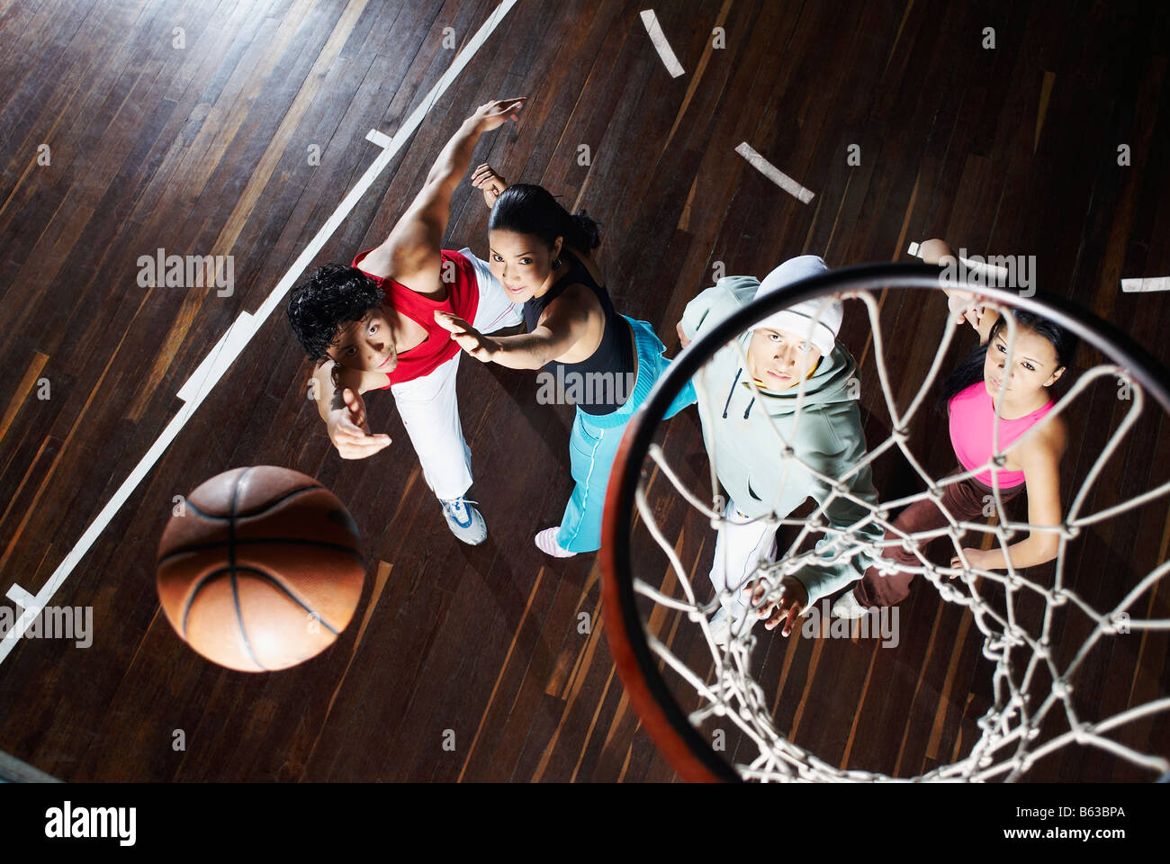 High angle view of two young men with two young women playing basketball Stock Photo