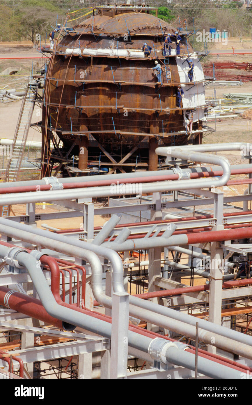 Construction workers working at under construction oil refinery Stock