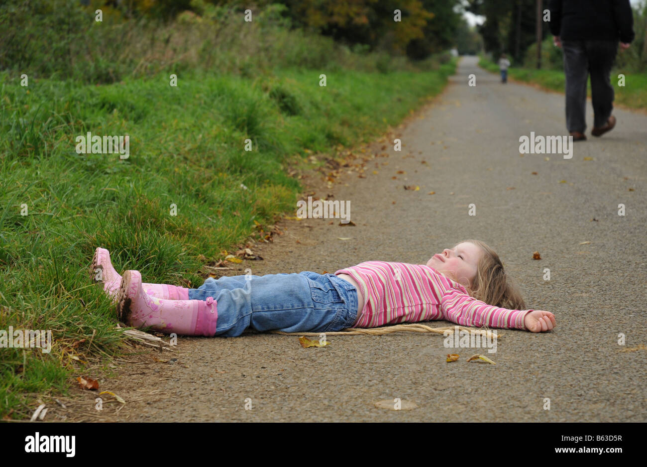 A young girl throws a tantrum during a walk in the countryside Stock