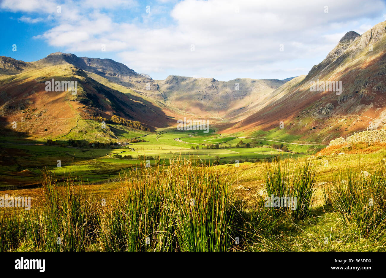 Autumn sunlight and clouds casts shadows over Langdale in the Lake District National Park, Cumbria, England, UK Stock Photo