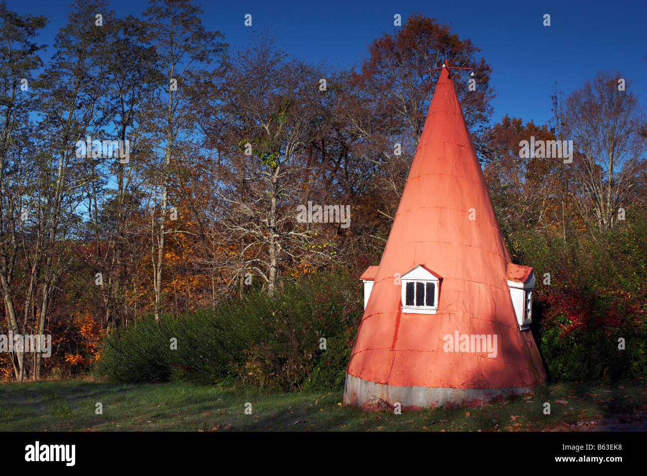 A curious structure that looks like a gnome house adjacent to the entrance driveway of a residence Stock Photo