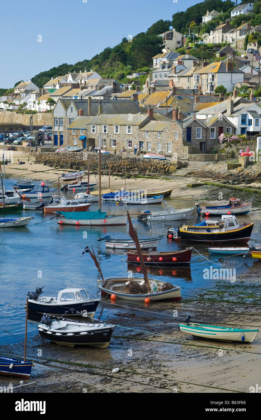 Fishing boats and old stone cottages in Mousehole Harbour, Near
