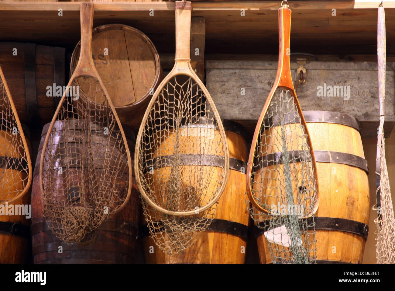 Old antique fishing equipment displayed at the Bass Pro Shop retail store  Items include fishing nets and wooden barrels Stock Photo - Alamy