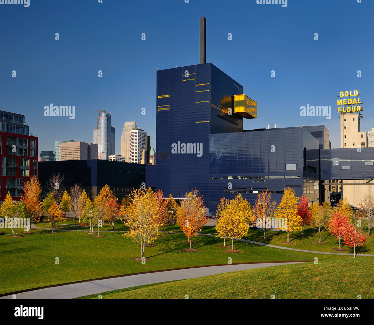 Colorful Maple trees at the Guthrie Theater in Minneapolis with Gold Medal Flour silos in Autumn Stock Photo