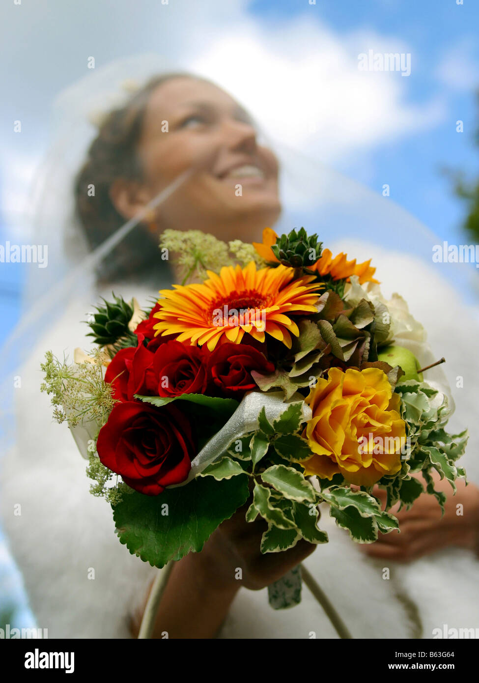 A portrait of a bride pictured on her wedding day holding bouquet focus on bouquet Stock Photo