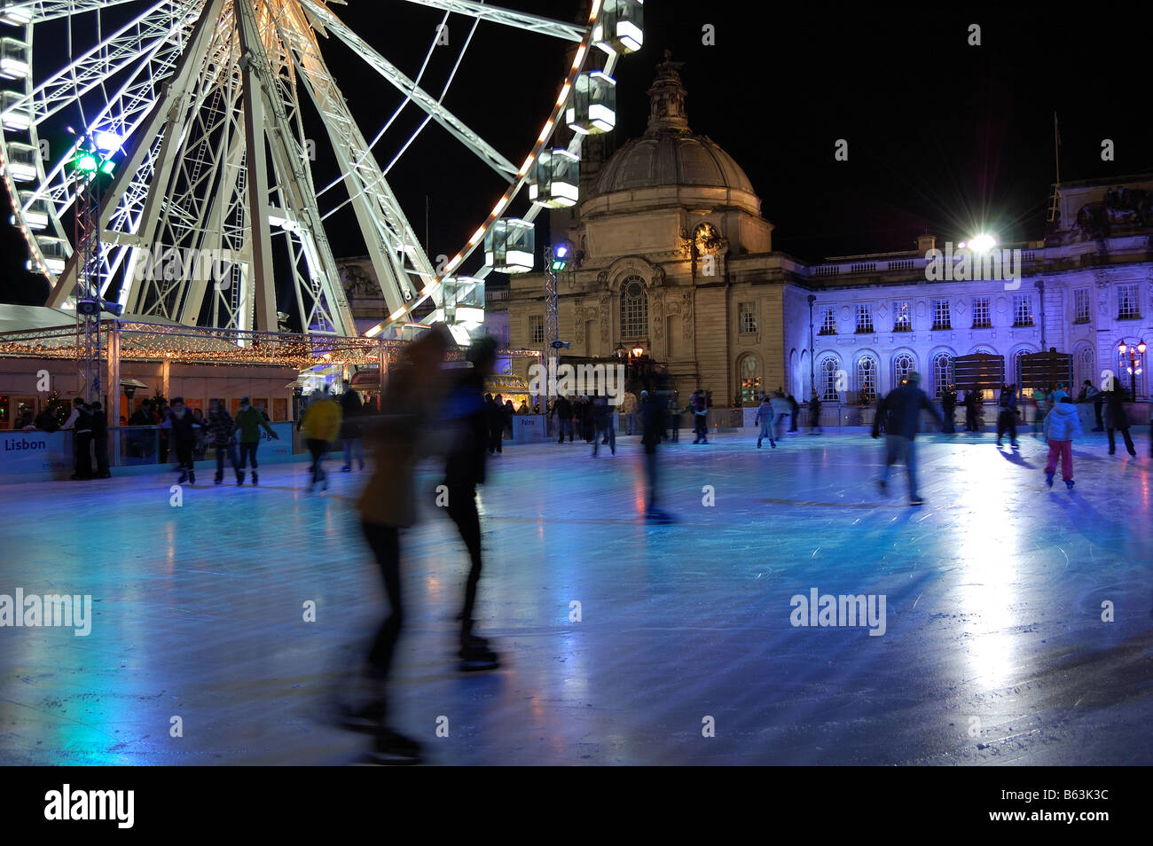 Night shot of two friends iceskating together at the winter wonderland