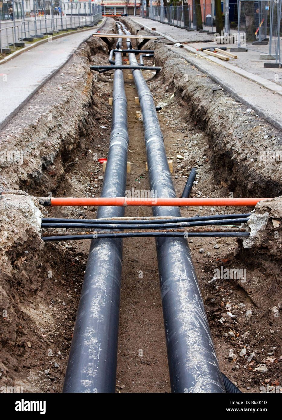 Pipes being laid in street Stock Photo
