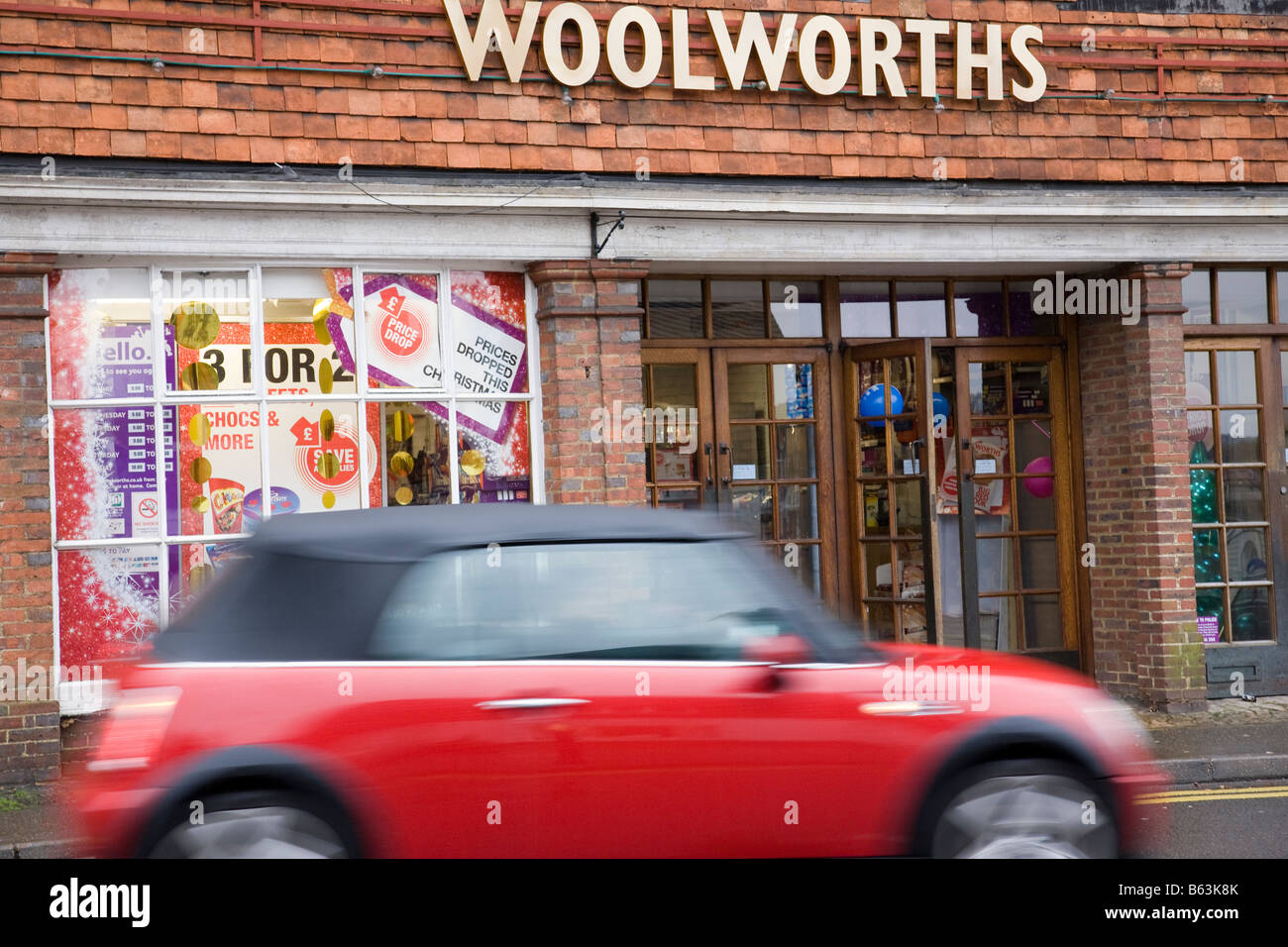 A Woolworths shop front with rare gold coloured signage, Haslemere, Surrey, England. Stock Photo