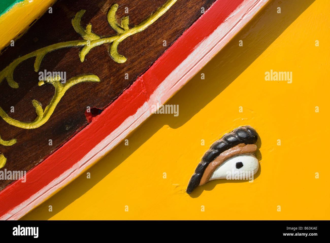 The bands of bright colours and the Eyes of Osiris on the prow of a Maltese traditional boat called luzzu in Malta Stock Photo