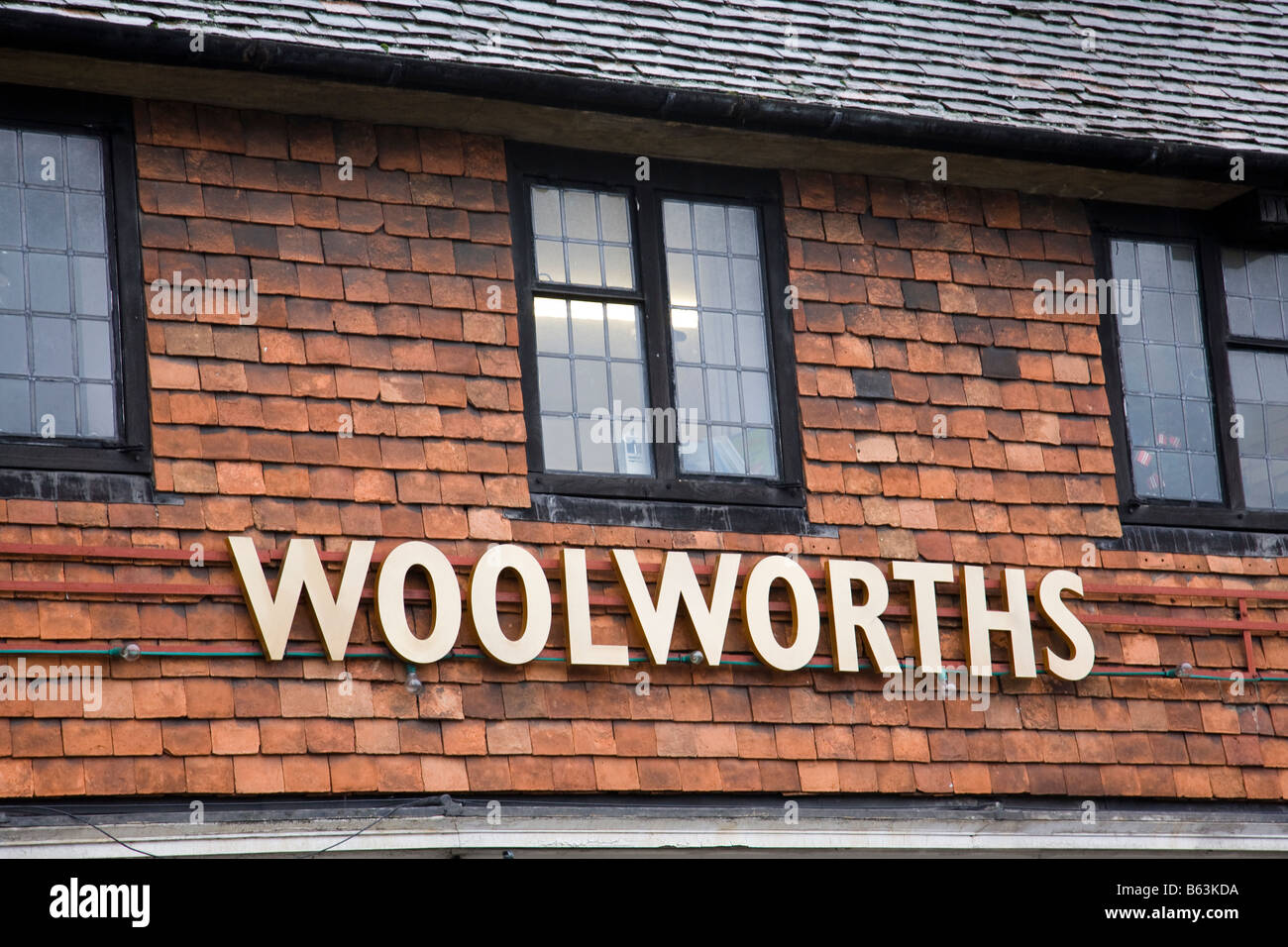Part of a Woolworths shop front showing the rare gold coloured signage, Haslemere, Surrey, England. Stock Photo