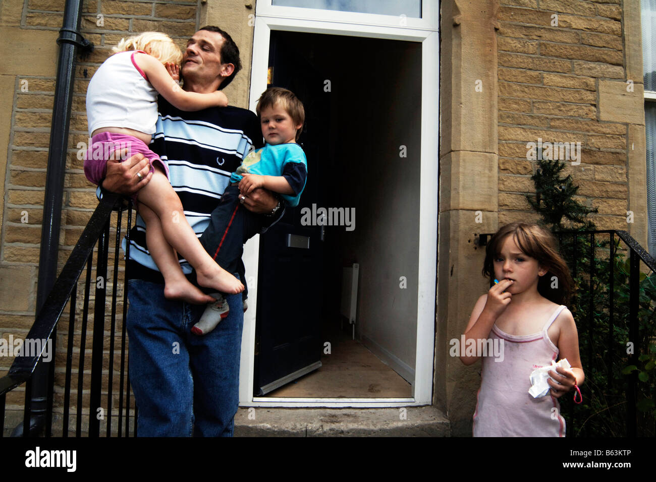 A father with his children living in poverty Bradford UK Stock Photo