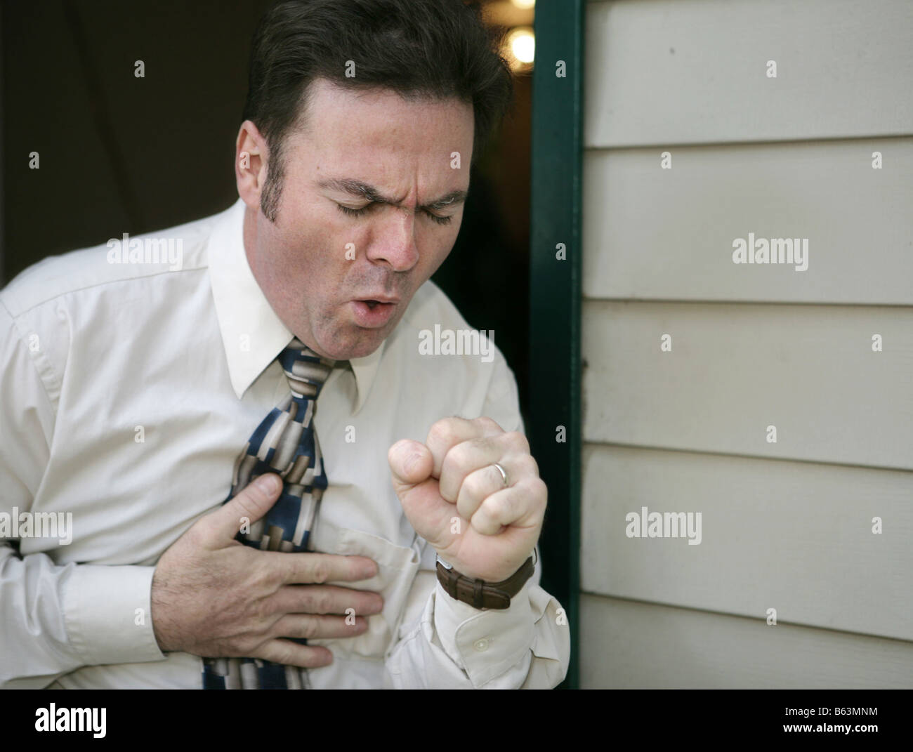 A man leaving work early because of a coughing fit Stock Photo Alamy