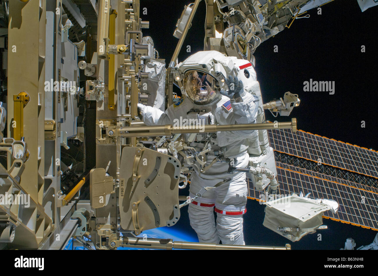 Astronaut Shane Kimbrough continus removing debris and applying lubrication around the starboard Solar Alpha Rotary Joint Stock Photo