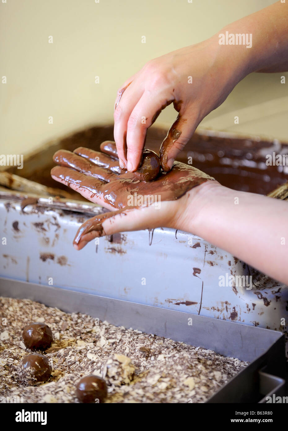 Truffles being rolled by hand before dipping in chocolate flakes. Picture by Jim Holden. Stock Photo