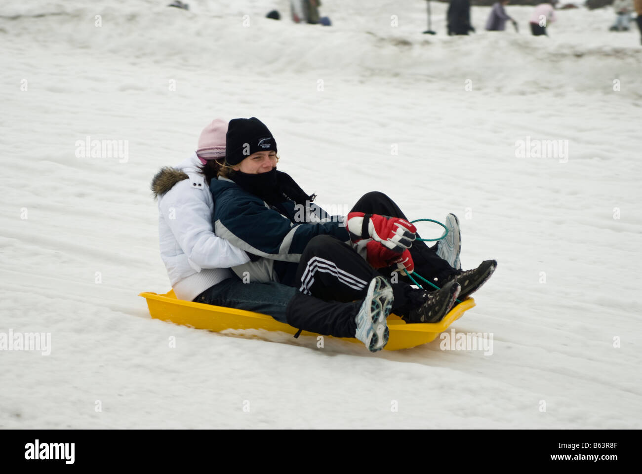 Boy girl sledding down snow hi res stock photography and images