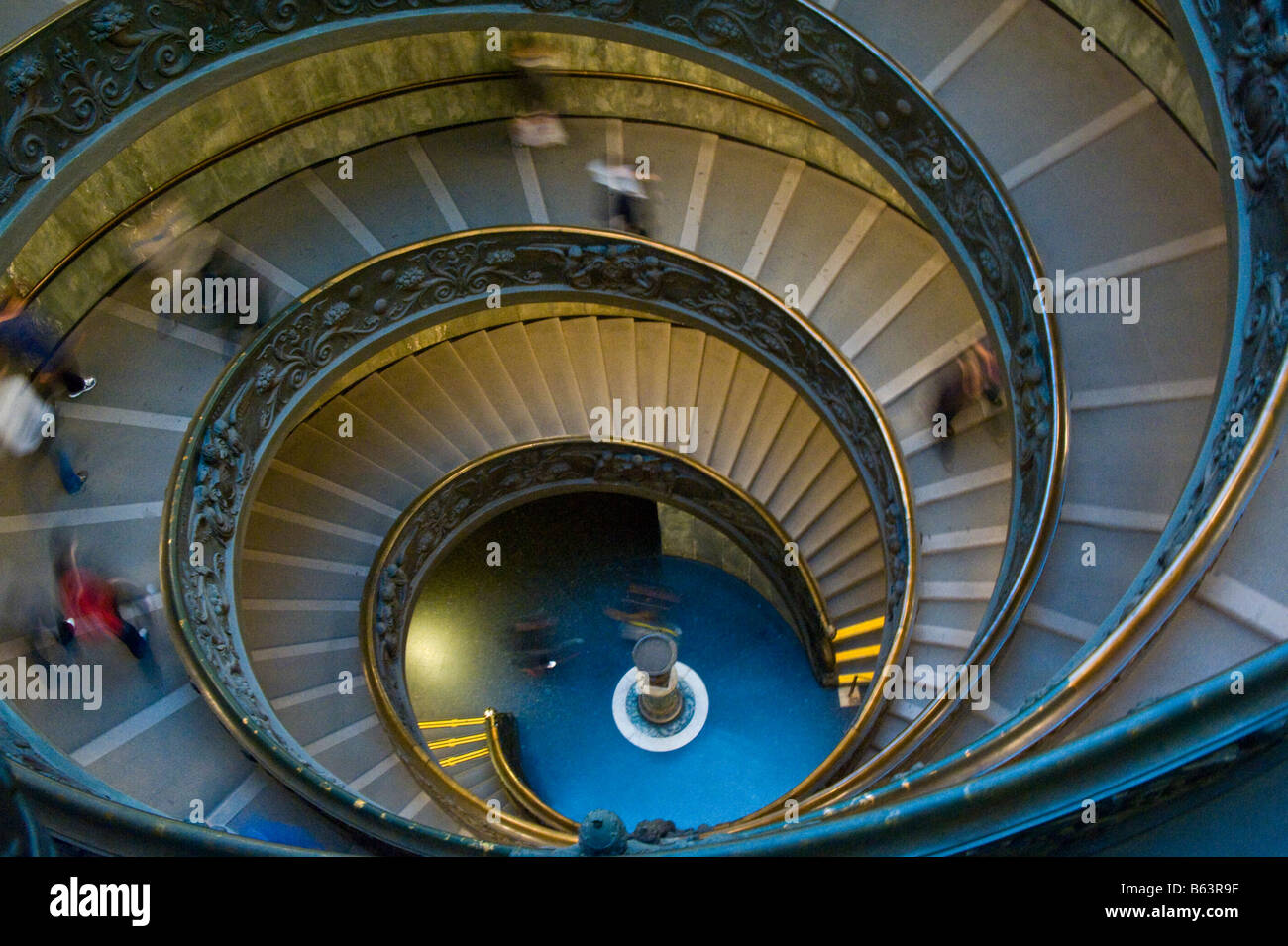 Blurred people walking down spiral staircase at the Vatican in Italy. Stock Photo