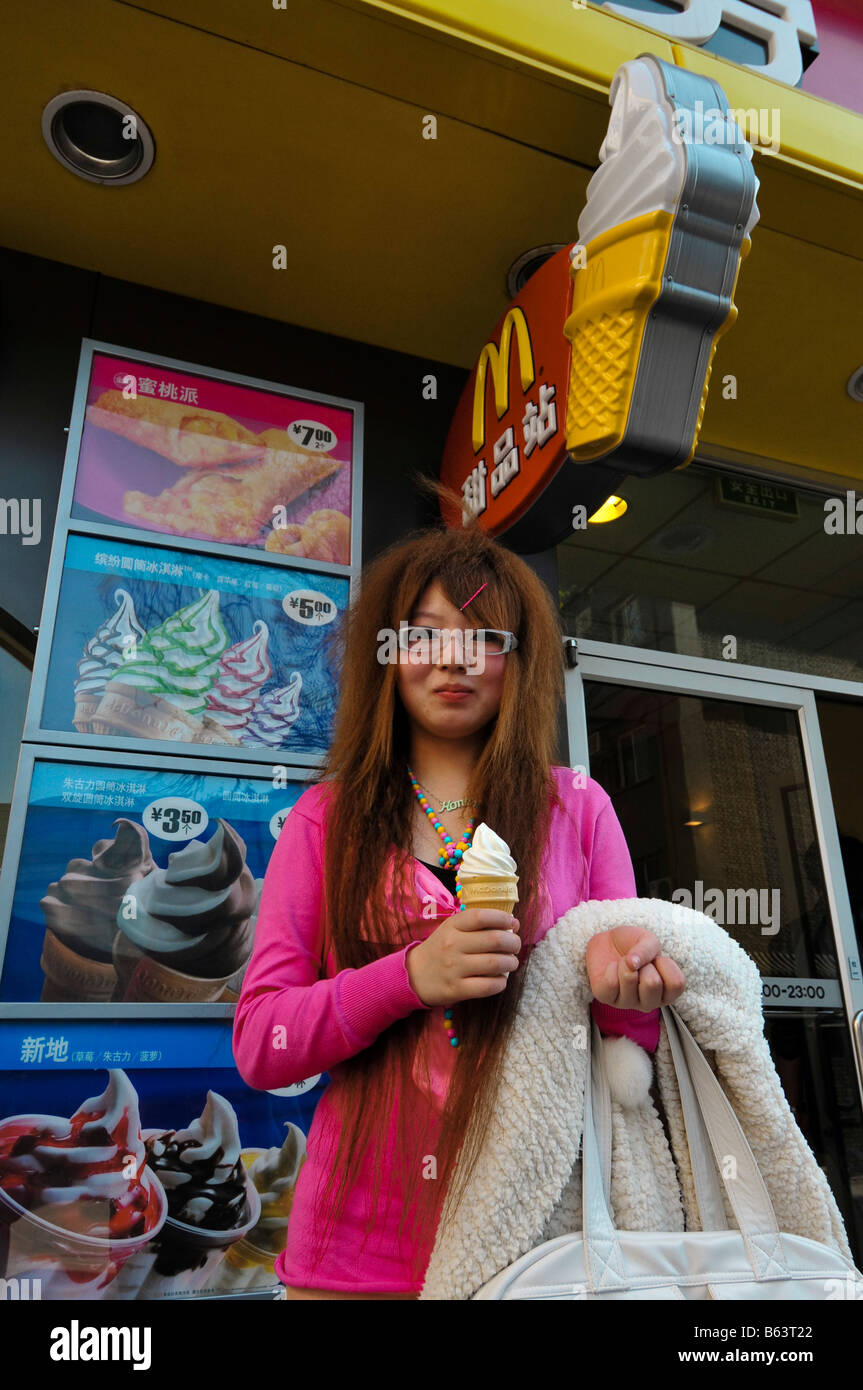 Young Trendy woman with ice cream in front of Beijing downtown McDonald's restaurant Stock Photo