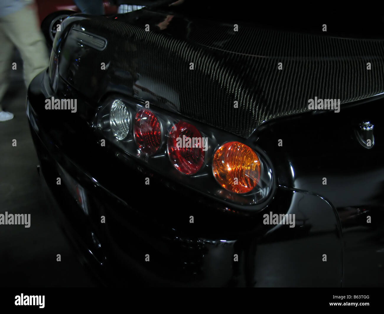 a closeup of a customized import sports car complete with a carbon