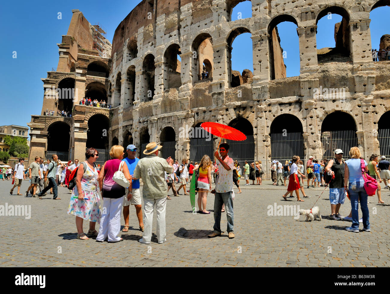 Immigrant sell sun umbrellas in the street to tourists by the Colosseum, Rome, Lazio, Italy, Europe. Stock Photo