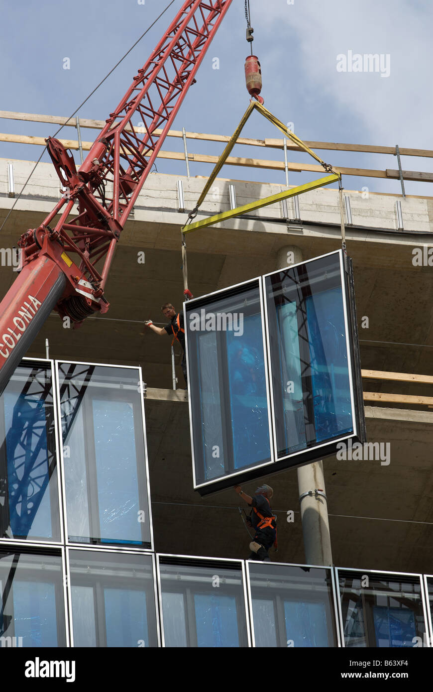 Glass windows being fitted to a prestigious office development, Cologne, North Rhine-Westphalia, Germany. Stock Photo