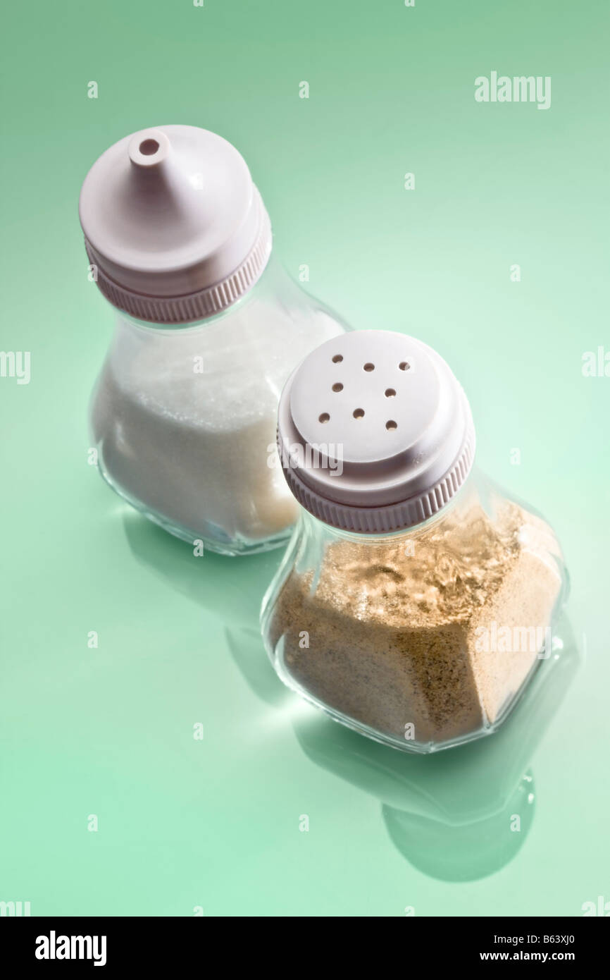 Salt and pepper on reflective surface Stock Photo