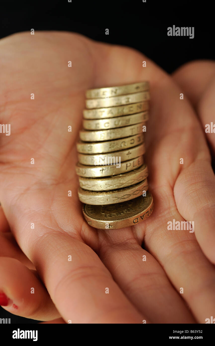 Pile of one pound coins in the palm of a hand © Mark Shenley Stock Photo