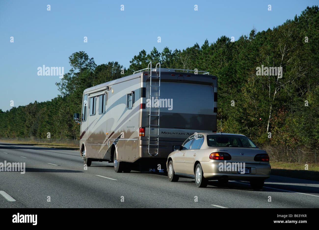 Mountain Aire RV southbound on Interstate 95 USA heading towards Florida America United States towing a Chevrolet Malibu car Stock Photo