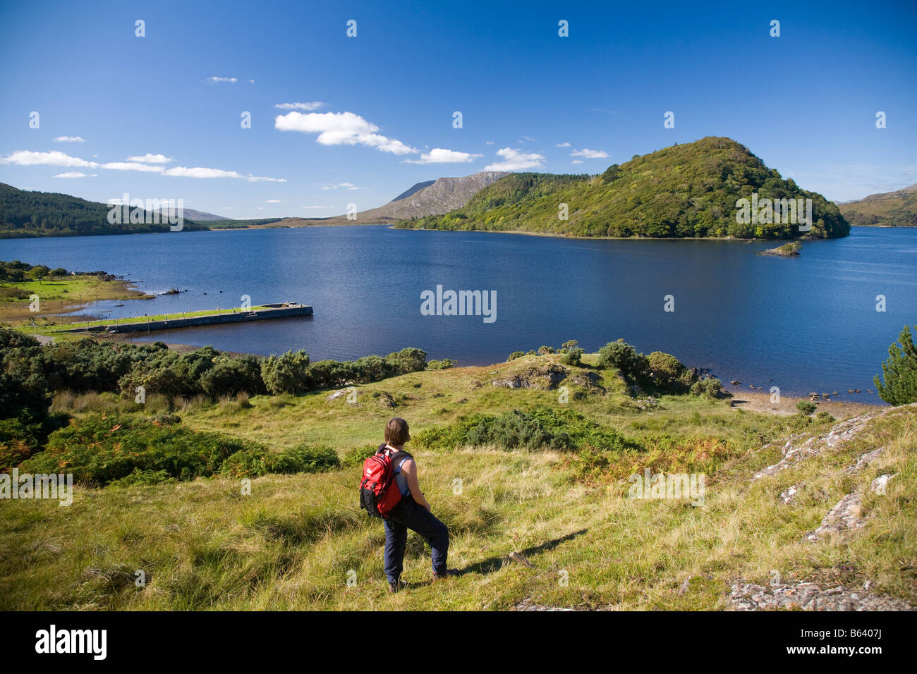 Walker looking over Lough Corrib and the Drumsnauv peninsula, County Galway, Ireland. Stock Photo