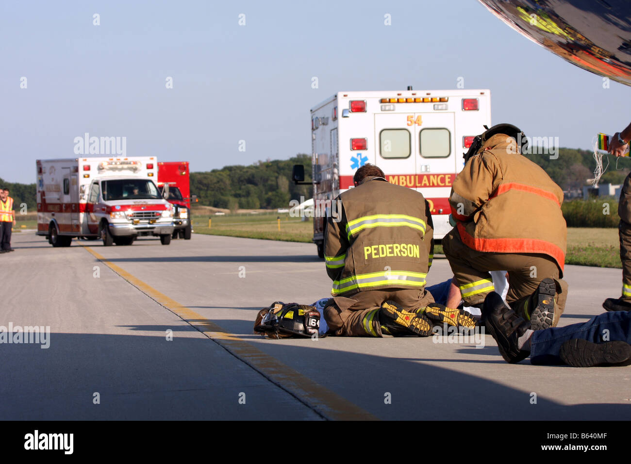 EMS personnel tagging an injured lady with more help arriving at an