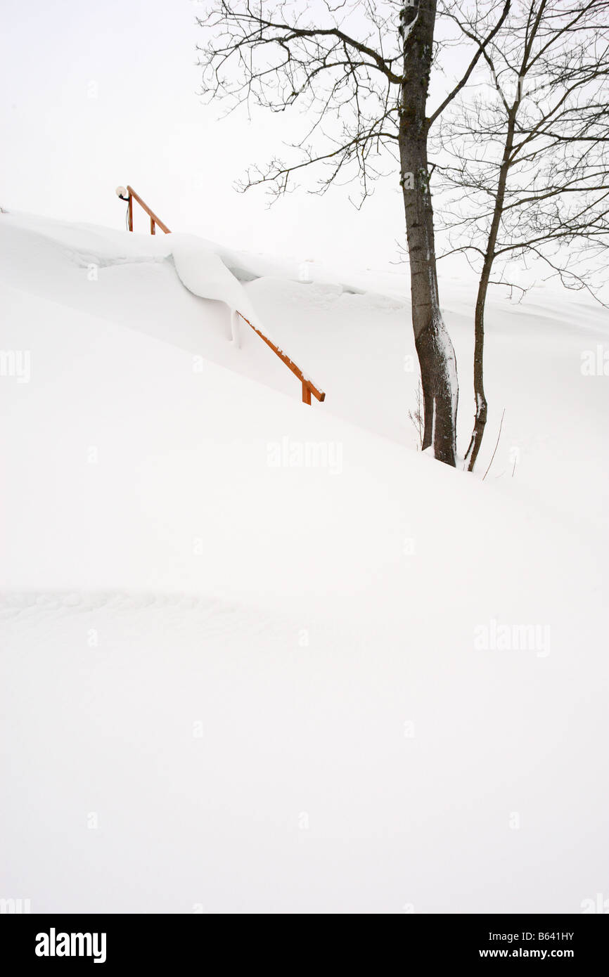A stair steps going up hill, covered in snow. Stock Photo