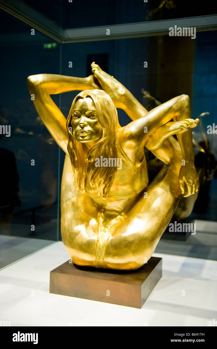 British Museum stunning modern art statue in gold  of The Siren , Kate Moss , by Marc Quinn pretty teenage girl in yoga position Stock Photo