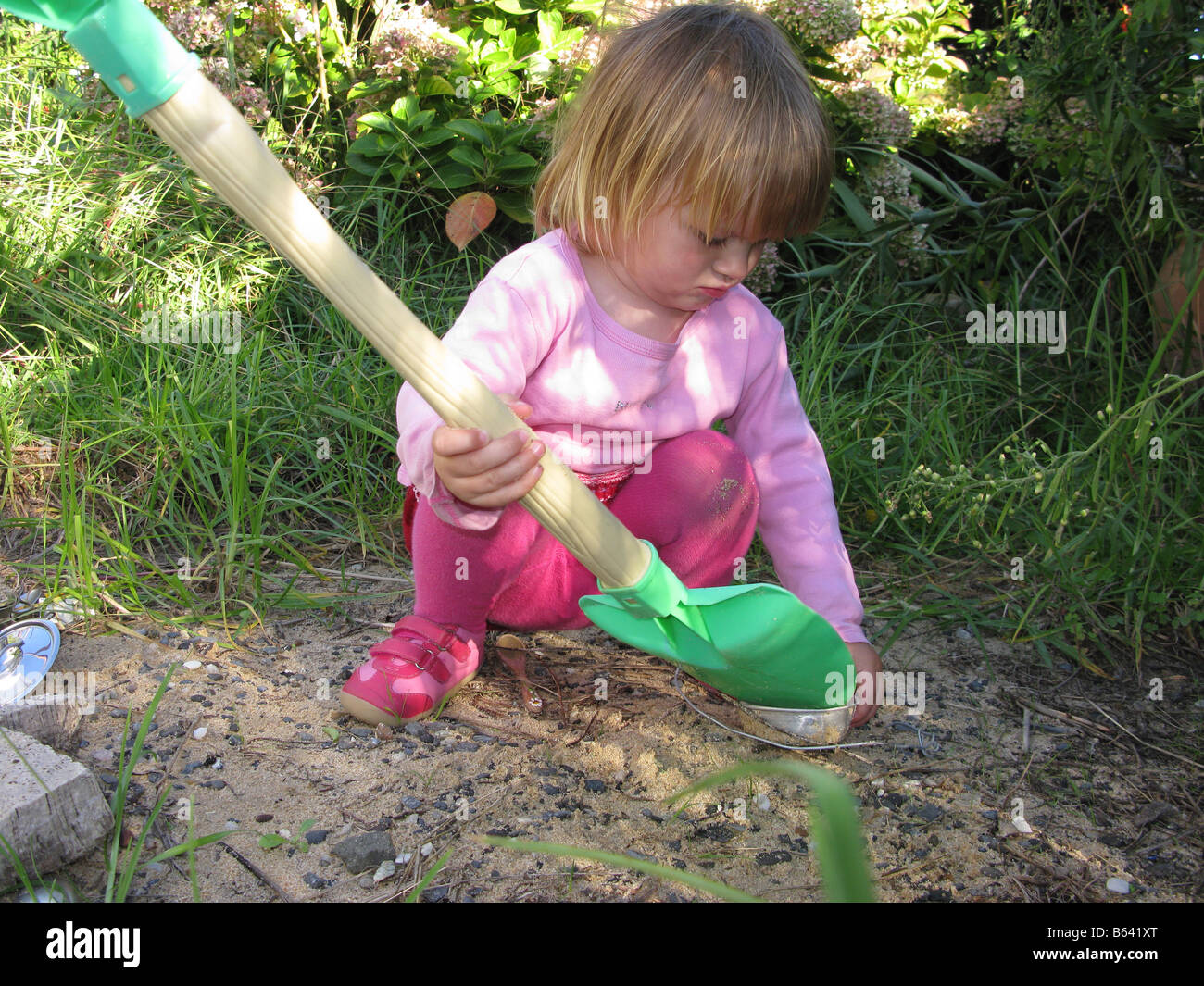 Child girl playing with spade Stock Photo Alamy